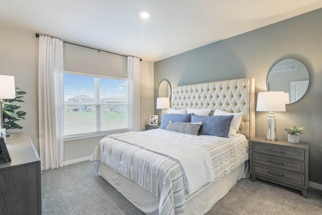 707 Thomas St, Tiffin, IA 52340 - bedroom featuring light carpet and baseboards