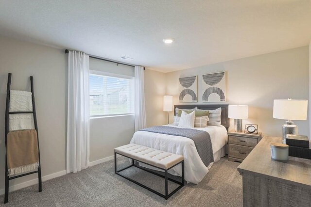 707 Thomas St, Tiffin, IA 52340 - bedroom with light carpet, baseboards, and visible vents