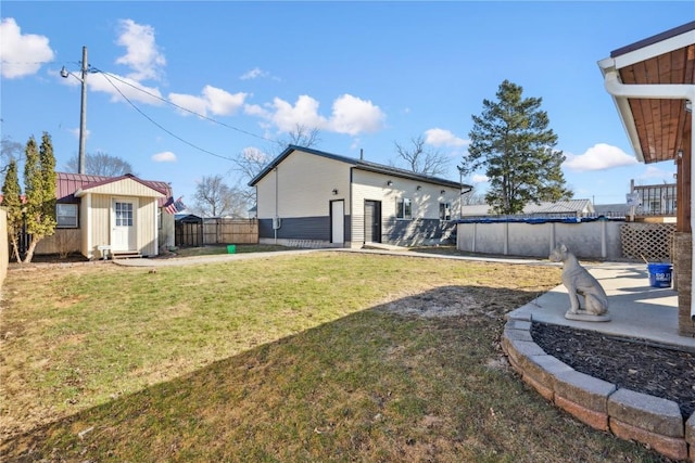 1305 W 4th St, Vinton, IA 52349 - view of yard featuring a fenced in pool, an outbuilding, a storage shed, a fenced backyard, and a patio