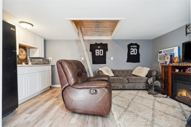 1305 W 4th St, Vinton, IA 52349 - living room with a glass covered fireplace and light wood-type flooring