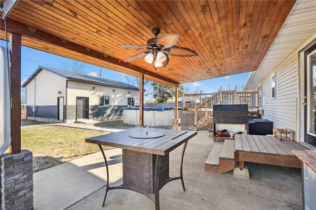 1305 W 4th St, Vinton, IA 52349 - view of patio featuring a ceiling fan, a covered pool, and a deck