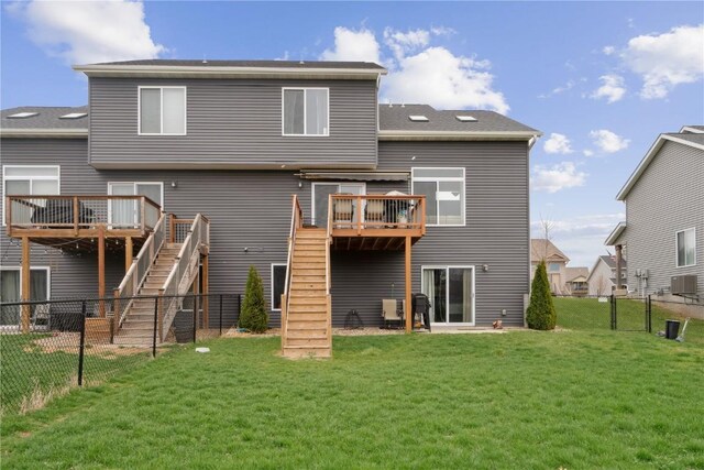 621 Doe Ave, Tiffin, IA 52340 - rear view of house with a fenced backyard, a yard, a deck, and stairs
