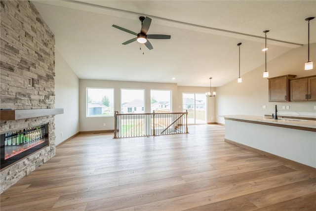 7102 Colpepper Dr SW, Cedar Rapids, IA 52404 - unfurnished living room featuring light wood-type flooring, plenty of natural light, and a fireplace
