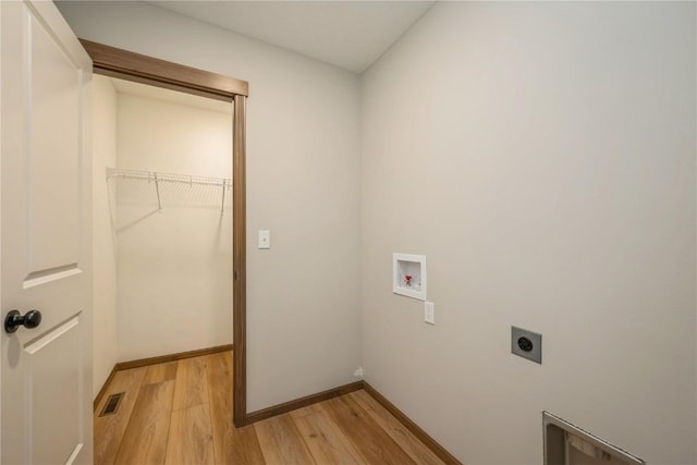 7102 Colpepper Dr SW, Cedar Rapids, IA 52404 - laundry room featuring hookup for an electric dryer, washer hookup, light wood-type flooring, and baseboards