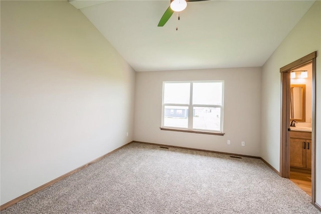 7102 Colpepper Dr SW, Cedar Rapids, IA 52404 - unfurnished bedroom featuring light carpet, lofted ceiling, baseboards, a sink, and ensuite bathroom
