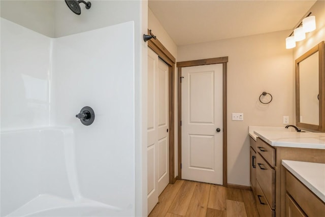 7102 Colpepper Dr SW, Cedar Rapids, IA 52404 - bathroom with vanity, wood finished floors, and a shower