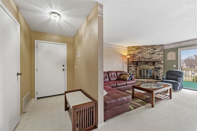 entrance foyer featuring a fireplace, visible vents, and a textured ceiling