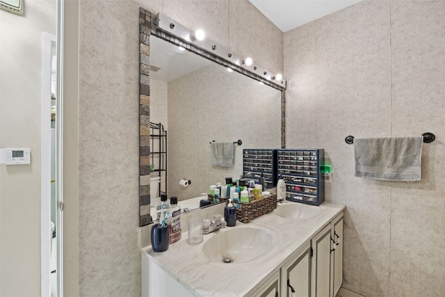 bathroom with double vanity and a sink