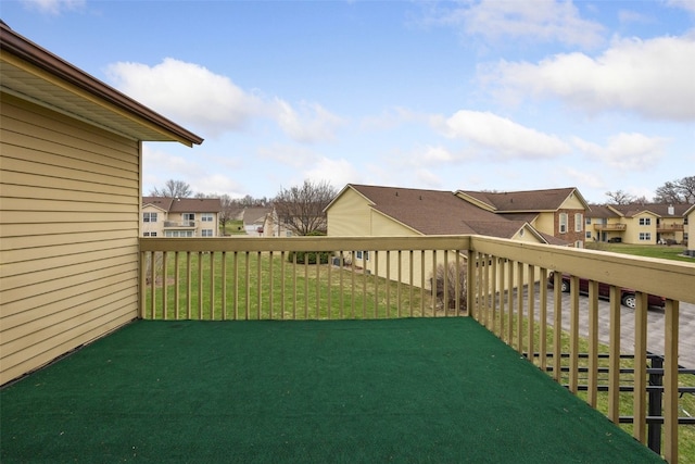 view of yard with a residential view and a balcony
