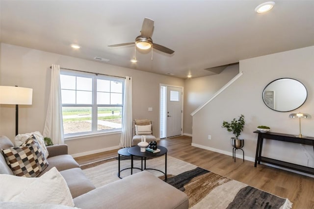 7014 C St SW, Cedar Rapids, IA 52404 - living area featuring wood finished floors, baseboards, ceiling fan, recessed lighting, and stairway