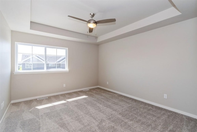 7014 C St SW, Cedar Rapids, IA 52404 - empty room featuring a raised ceiling, carpet flooring, and ceiling fan