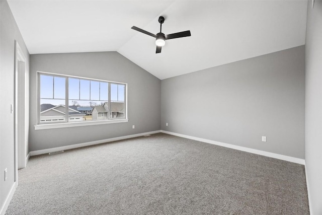 empty room with baseboards, vaulted ceiling, ceiling fan, and carpet flooring