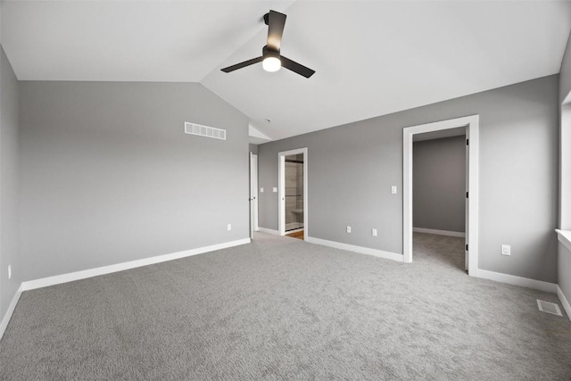 carpeted empty room featuring baseboards, lofted ceiling, ceiling fan, and visible vents