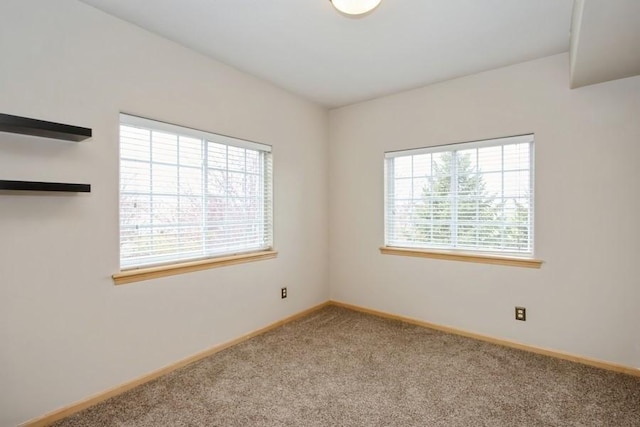 spare room with carpet and baseboards