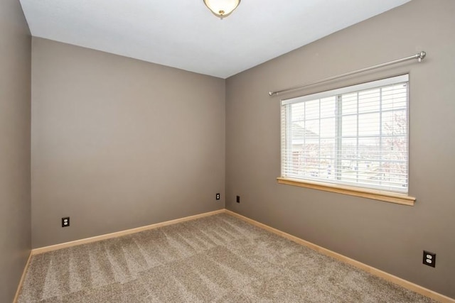 empty room with carpet and baseboards