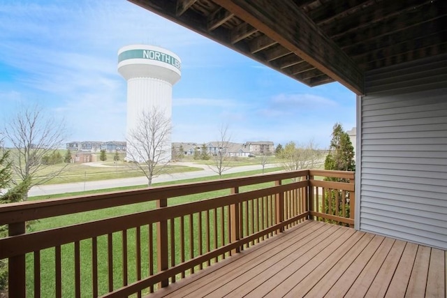 wooden terrace featuring a yard