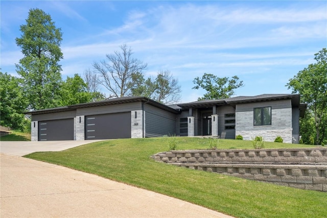 1509 Aspen Cir SE, Cedar Rapids, IA 52403 - view of front of house featuring stone siding, an attached garage, driveway, and a front yard