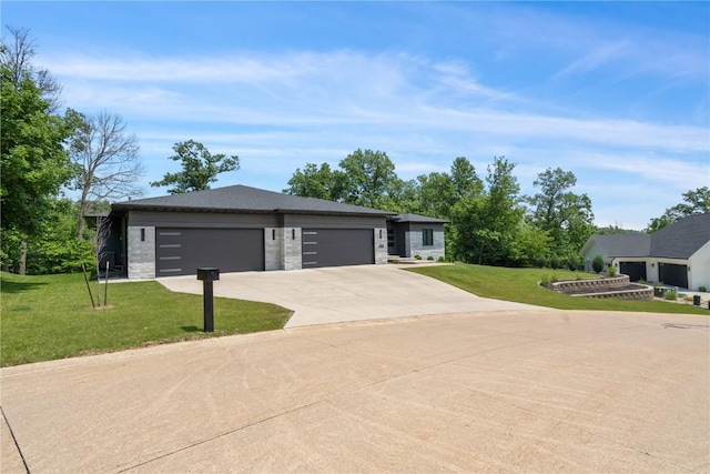 1509 Aspen Cir SE, Cedar Rapids, IA 52403 - view of front facade featuring driveway, a garage, a front lawn, and stone siding