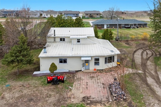 5503 Smithland Dr, Marion, IA 52302 - back of property featuring a standing seam roof, metal roof, and a residential view