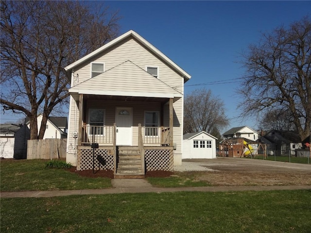 549 Marengo Ave, Marengo, IA 52301 - view of front of property featuring fence, a front lawn, and covered porch