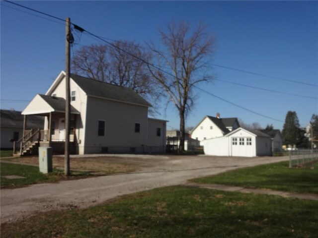 549 Marengo Ave, Marengo, IA 52301 - view of side of property featuring a garage, a yard, and driveway