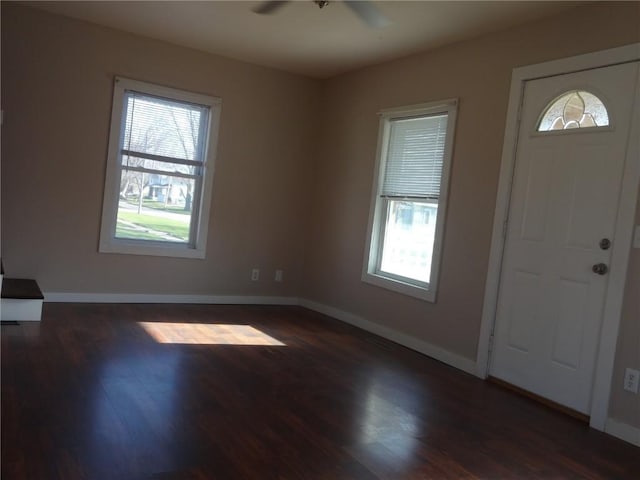 549 Marengo Ave, Marengo, IA 52301 - foyer with dark wood-style flooring, baseboards, a ceiling fan, and plenty of natural light