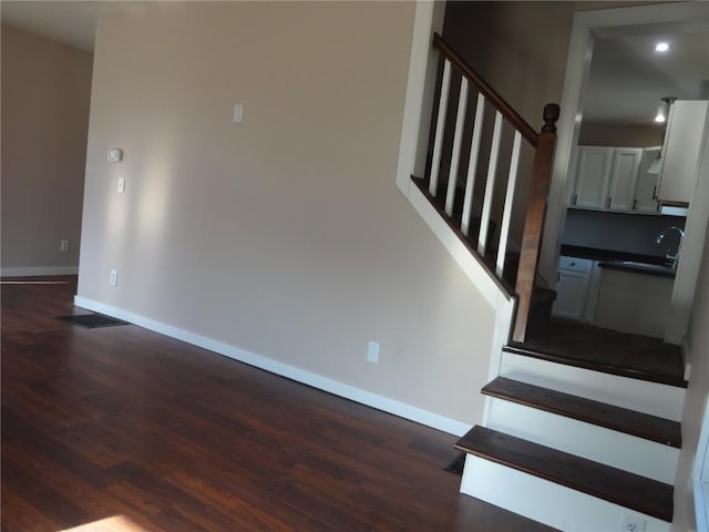 549 Marengo Ave, Marengo, IA 52301 - staircase featuring wood finished floors, baseboards, visible vents, and recessed lighting