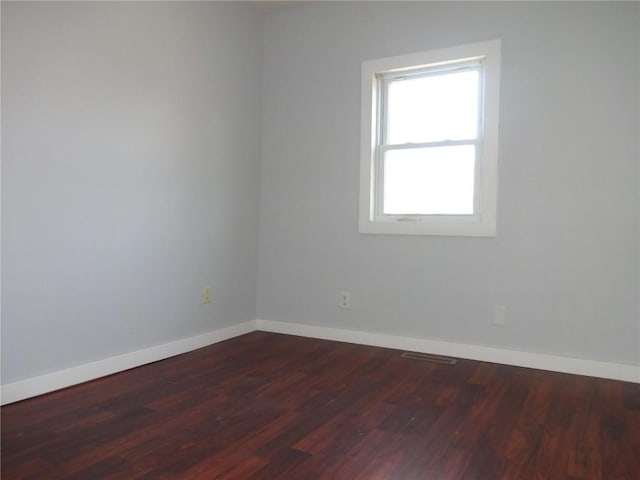 549 Marengo Ave, Marengo, IA 52301 - empty room with baseboards and dark wood-style floors