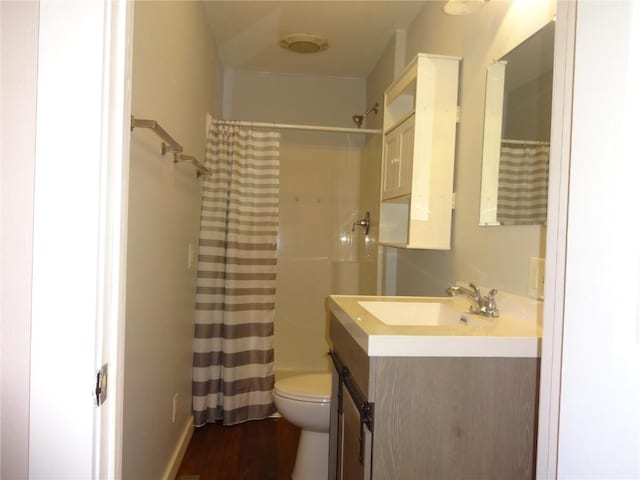 549 Marengo Ave, Marengo, IA 52301 - bathroom featuring toilet, curtained shower, wood finished floors, and vanity