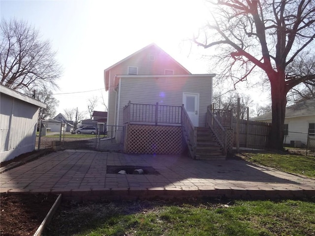 549 Marengo Ave, Marengo, IA 52301 - rear view of house with fence, a deck, a patio, and stairway