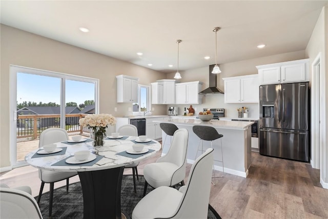 dining area featuring wood finished floors and recessed lighting