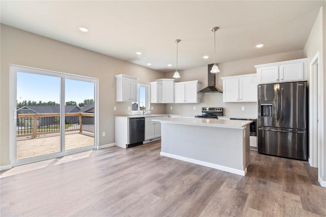 1306 E Gable Way, Tiffin, IA 52340 - kitchen with appliances with stainless steel finishes, wall chimney range hood, light countertops, wood finished floors, and a center island