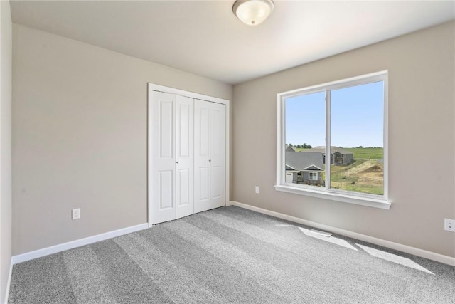 1306 E Gable Way, Tiffin, IA 52340 - unfurnished bedroom featuring baseboards, carpet flooring, and a closet