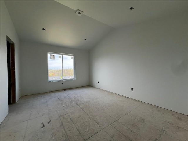 spare room with lofted ceiling