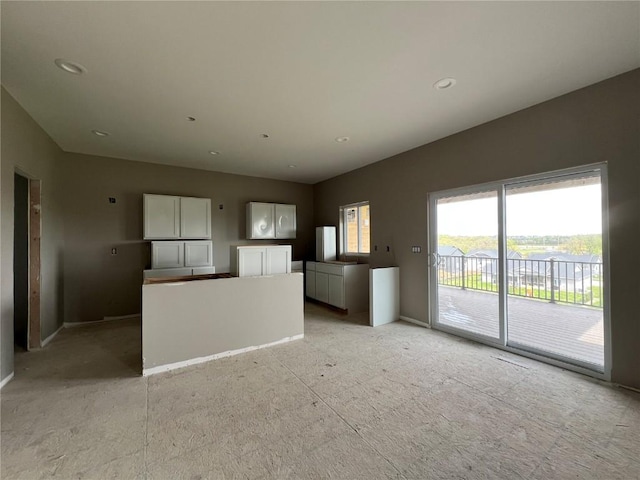1306 E Gable Way, Tiffin, IA 52340 - unfurnished living room with baseboards and recessed lighting