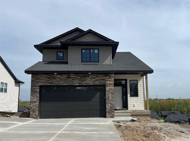 view of front of property featuring concrete driveway, a garage, stone siding, and a shingled roof