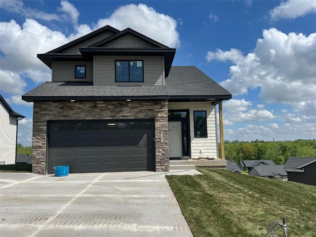 1306 E Gable Way, Tiffin, IA 52340 - view of front of house with a garage, concrete driveway, stone siding, a front yard, and roof with shingles