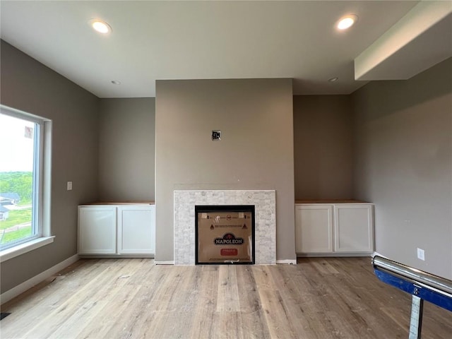 1306 E Gable Way, Tiffin, IA 52340 - unfurnished living room with wood finished floors, a fireplace, baseboards, and recessed lighting
