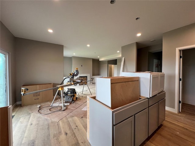 1306 E Gable Way, Tiffin, IA 52340 - kitchen with light wood-style flooring, a kitchen island, and recessed lighting