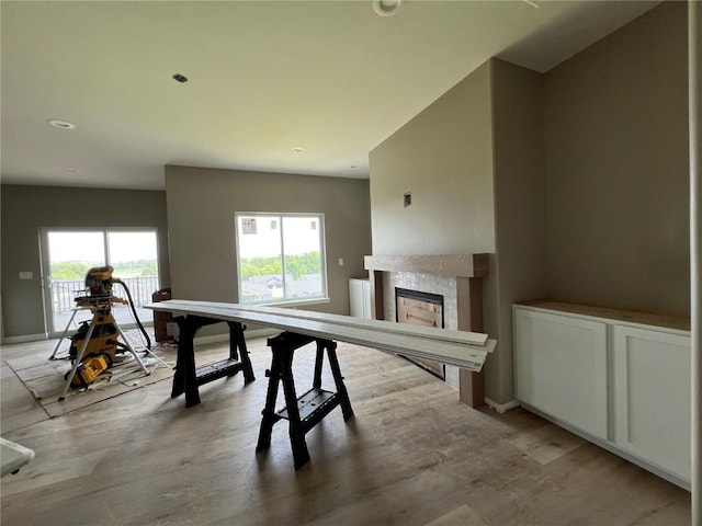 1306 E Gable Way, Tiffin, IA 52340 - rec room with a tile fireplace, light wood finished floors, and baseboards