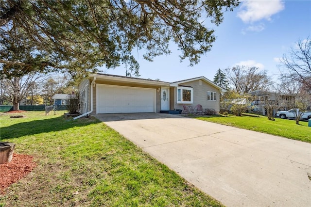 ranch-style house with a front yard, an attached garage, and concrete driveway