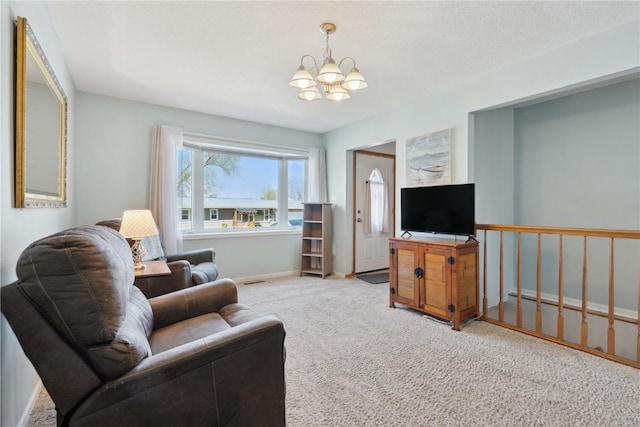 living area with baseboards, an inviting chandelier, and carpet floors