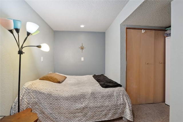 bedroom with carpet floors, a closet, and a textured ceiling