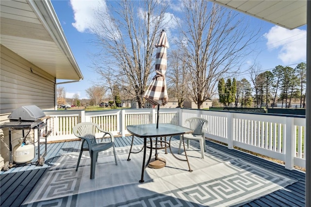 deck featuring outdoor dining area and area for grilling