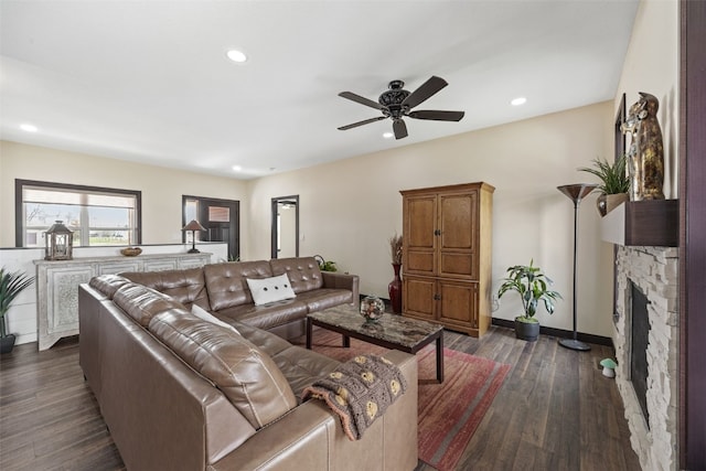 living room with baseboards, recessed lighting, dark wood finished floors, a fireplace, and a ceiling fan