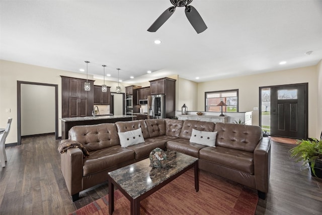 living area featuring dark wood finished floors, recessed lighting, ceiling fan, and baseboards