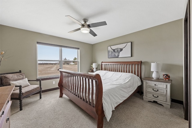 bedroom featuring ceiling fan, baseboards, and light carpet