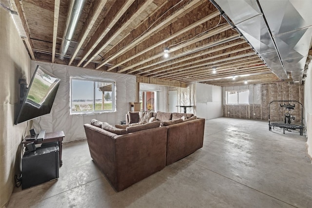 living room featuring unfinished concrete flooring