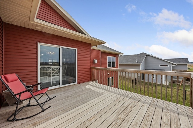 wooden deck with a lawn