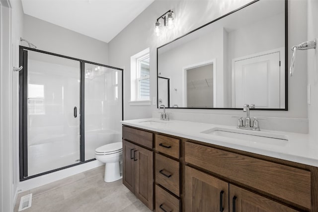 1442 Cardinal Dr, Fairfax, IA 52228 - full bathroom featuring a shower stall, double vanity, and a spacious closet